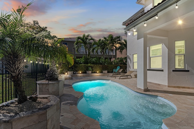 view of swimming pool featuring a fenced in pool, a patio area, and fence