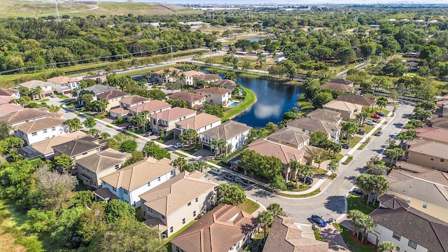 birds eye view of property featuring a water view and a residential view