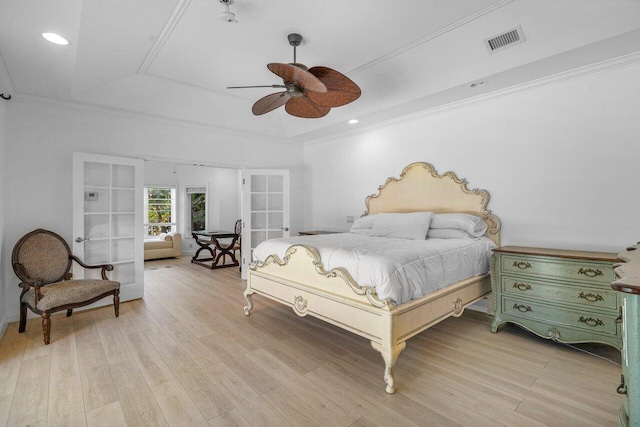 bedroom featuring ornamental molding, wood finished floors, and visible vents