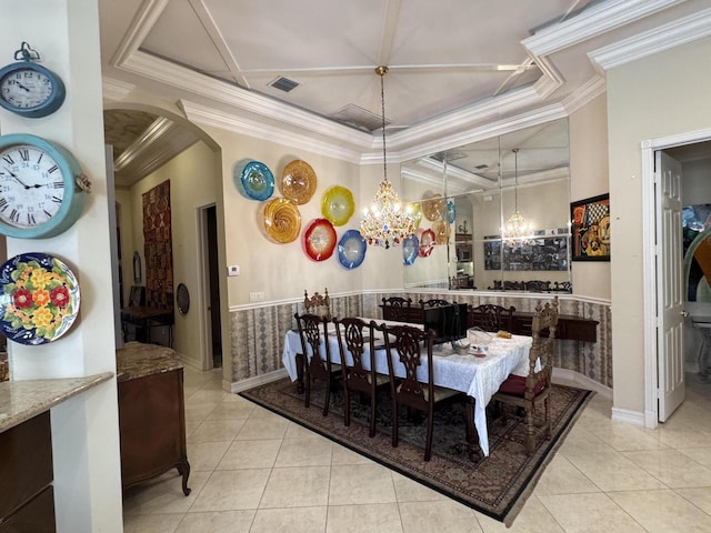 tiled dining area with arched walkways, visible vents, ornamental molding, a raised ceiling, and an inviting chandelier