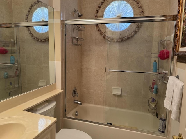 full bathroom with a wealth of natural light, vanity, toilet, and bath / shower combo with glass door