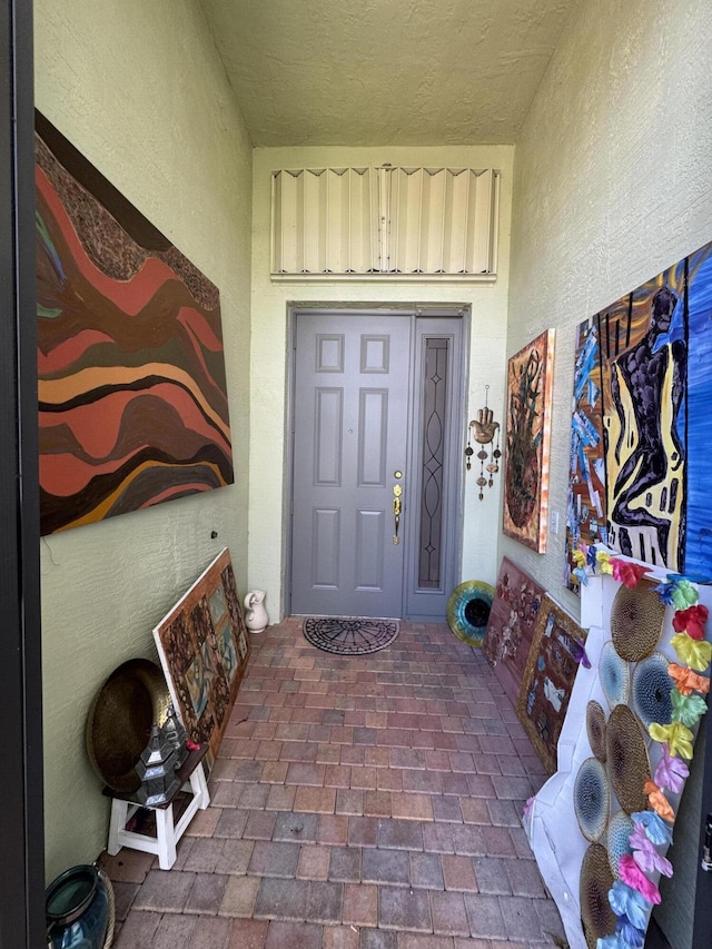 property entrance featuring stucco siding