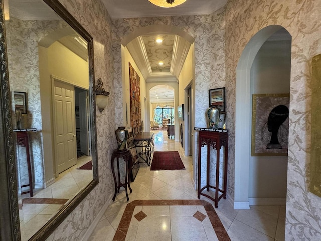 corridor with baseboards, arched walkways, crown molding, and tile patterned floors