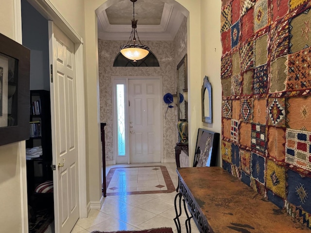 entrance foyer with crown molding, light tile patterned floors, a raised ceiling, baseboards, and wallpapered walls