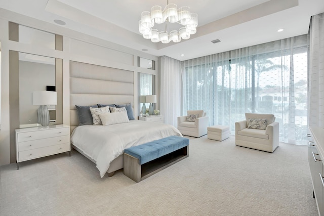 carpeted bedroom featuring a raised ceiling, visible vents, and an inviting chandelier