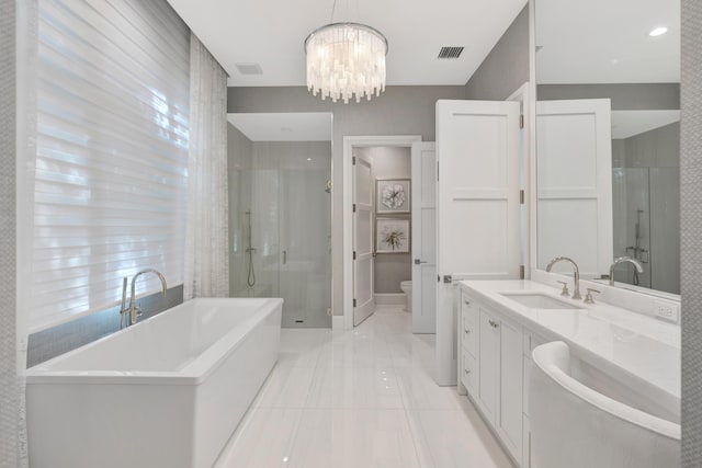 bathroom with a freestanding tub, a sink, visible vents, double vanity, and a stall shower