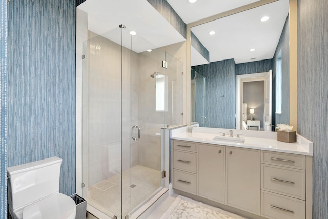 ensuite bathroom with recessed lighting, toilet, a shower stall, ensuite bath, and vanity