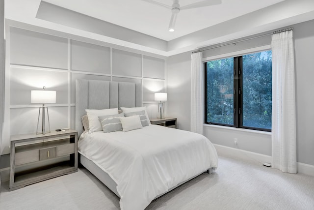 carpeted bedroom with a ceiling fan and baseboards