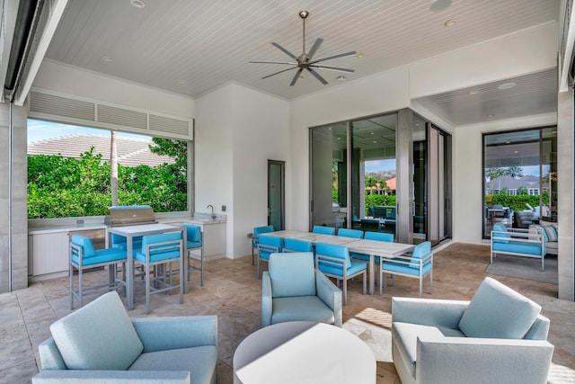 view of patio / terrace with a ceiling fan, outdoor lounge area, exterior kitchen, and outdoor dining space