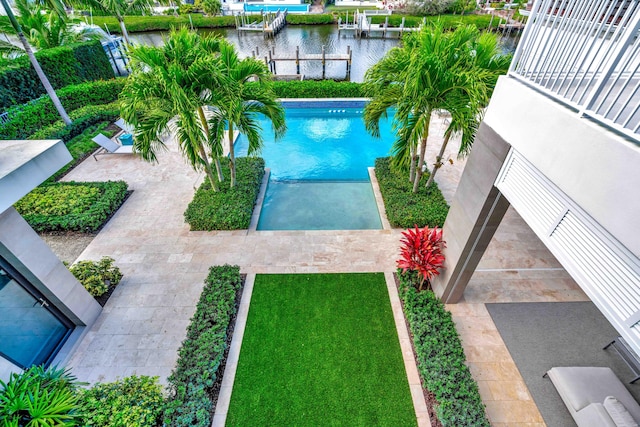 pool with a dock, a water view, and a patio