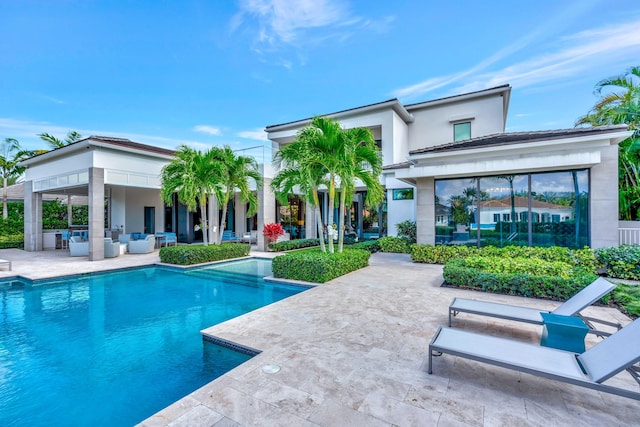 back of house featuring a patio, an outdoor living space, and an outdoor pool