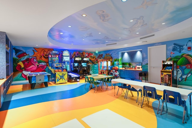 playroom with visible vents, a raised ceiling, and recessed lighting