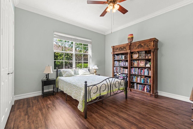 bedroom with baseboards, wood finished floors, a ceiling fan, and crown molding