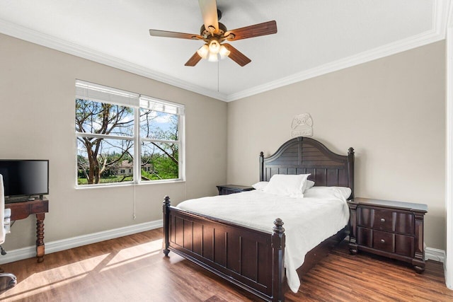 bedroom with a ceiling fan, baseboards, dark wood-type flooring, and ornamental molding