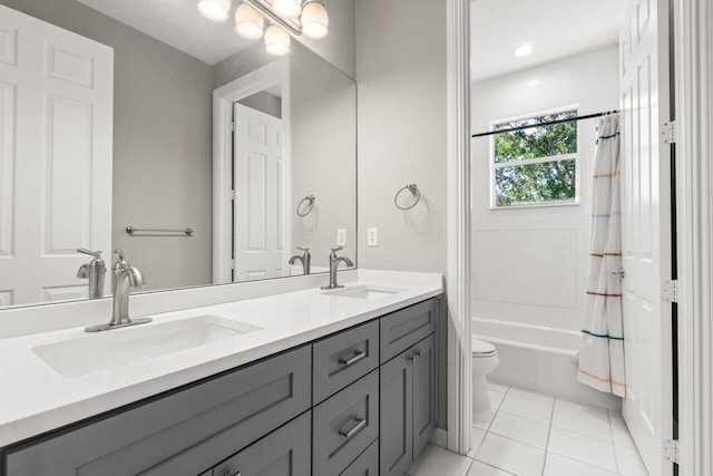 bathroom featuring double vanity, shower / bath combination with curtain, a sink, and toilet