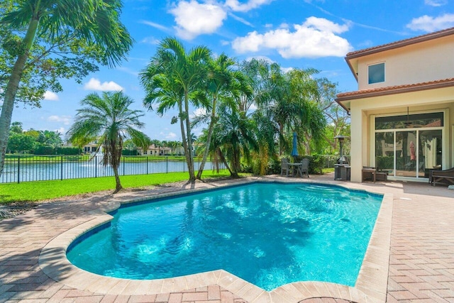 view of swimming pool with a fenced in pool, a water view, a patio, and fence