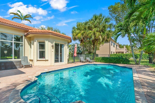 view of swimming pool with fence, a fenced in pool, and a patio