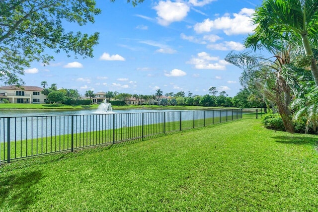 view of yard featuring a water view and fence