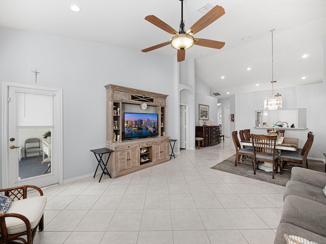 living area with recessed lighting, visible vents, light tile patterned flooring, high vaulted ceiling, and ceiling fan with notable chandelier