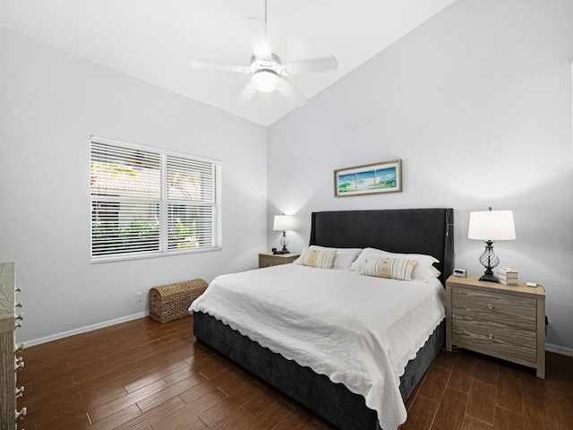 bedroom with dark wood-style floors, lofted ceiling, and baseboards