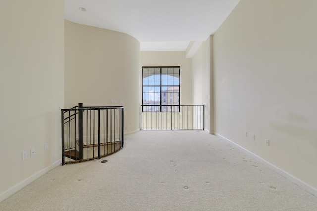 carpeted empty room with baseboards