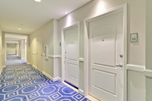 hallway with carpet, recessed lighting, and baseboards