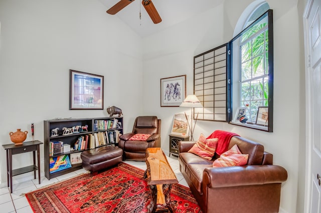 living area featuring ceiling fan, tile patterned flooring, and vaulted ceiling