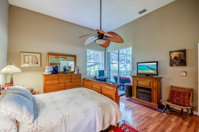 6861 Briarlake Cir, Palm Beach Gardens, FL 33418 - bedroom with wood finished floors, high vaulted ceiling, and a ceiling fan