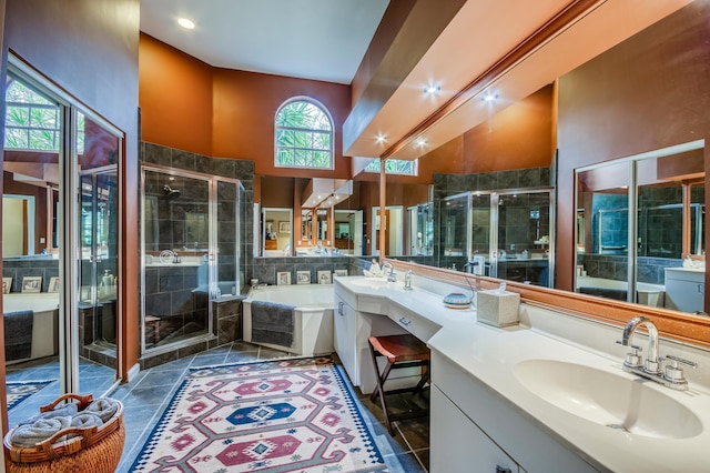 bathroom featuring a garden tub, a sink, and a shower stall