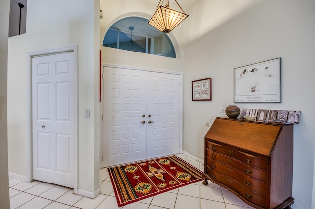 6861 Briarlake Cir, Palm Beach Gardens, FL 33418 - entrance foyer featuring a towering ceiling, baseboards, and light tile patterned flooring