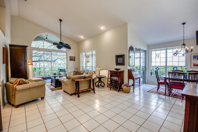 living room featuring light tile patterned floors, high vaulted ceiling, and ceiling fan with notable chandelier