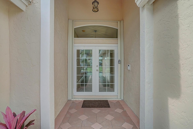 property entrance featuring french doors and stucco siding