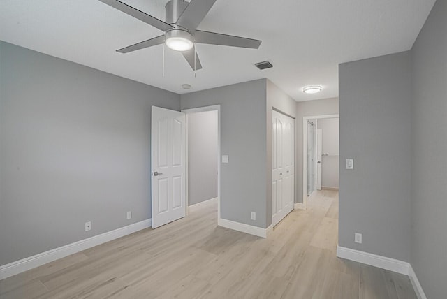 unfurnished bedroom with light wood-style floors, visible vents, and baseboards