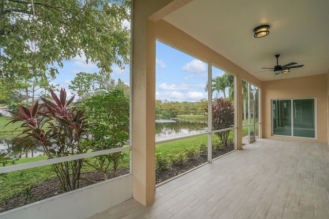 unfurnished sunroom with a water view