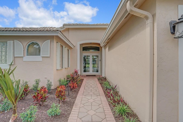 property entrance with french doors and stucco siding