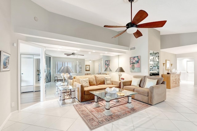 living area featuring light tile patterned floors, ceiling fan, visible vents, and high vaulted ceiling