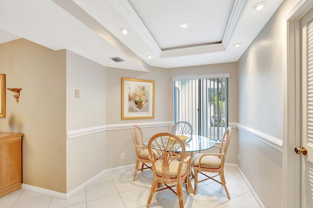 dining area with a raised ceiling, visible vents, crown molding, and baseboards