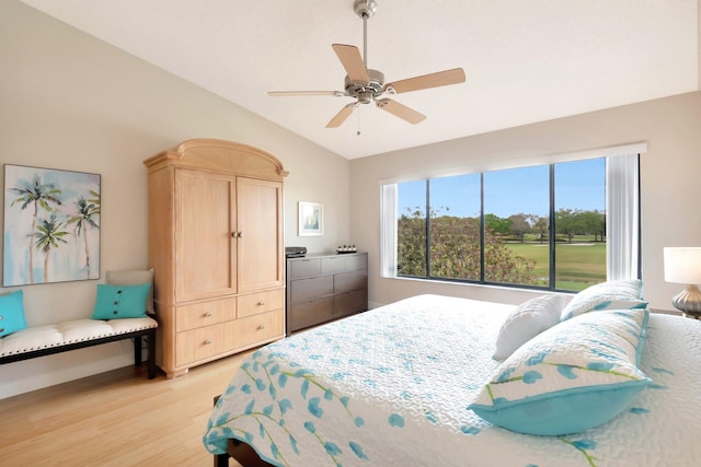 bedroom with vaulted ceiling, ceiling fan, and light wood finished floors