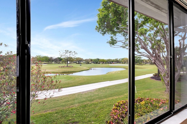 exterior space with view of golf course and a water view