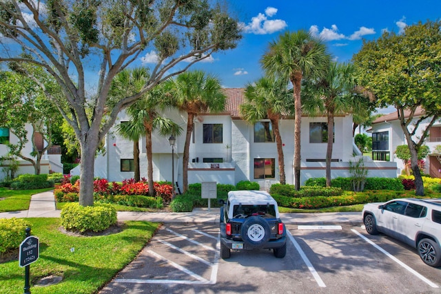 view of property featuring uncovered parking