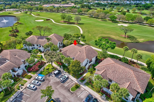 drone / aerial view with a residential view and golf course view