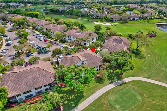 bird's eye view featuring golf course view, a water view, and a residential view