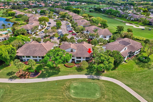 aerial view with view of golf course, a water view, and a residential view