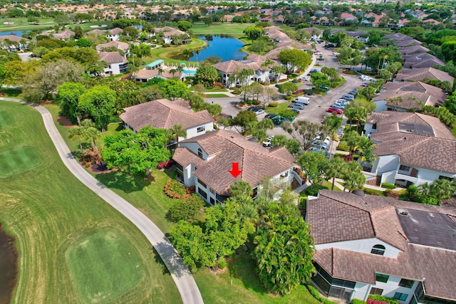 birds eye view of property featuring view of golf course, a water view, and a residential view