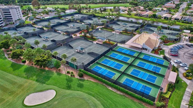 bird's eye view with a water view, view of golf course, and a residential view