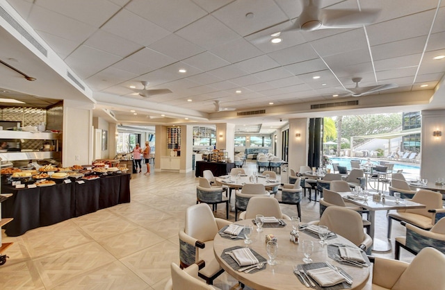 dining room with a raised ceiling, visible vents, and recessed lighting