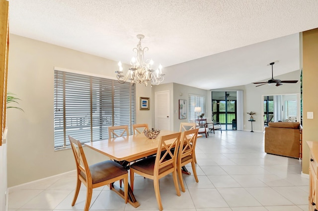 dining room featuring lofted ceiling, light tile patterned floors, and a textured ceiling