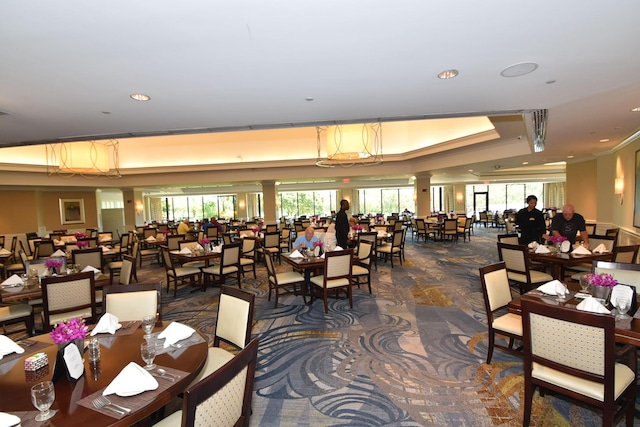 dining area with a healthy amount of sunlight, ornate columns, a tray ceiling, and recessed lighting