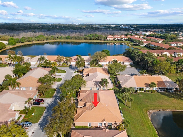 drone / aerial view with a water view and a residential view