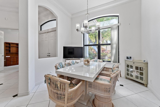 dining space with arched walkways, crown molding, light tile patterned flooring, a chandelier, and baseboards